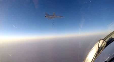 A still image, taken from video footage and released by Russia's Defence Ministry on August 11, 2016, shows a Russian Tupolev Tu-22M3 long-range bomber dropping off bombs at an unknown location in Syria. Ministry of Defence of the Russian Federation/Handout via REUTERS