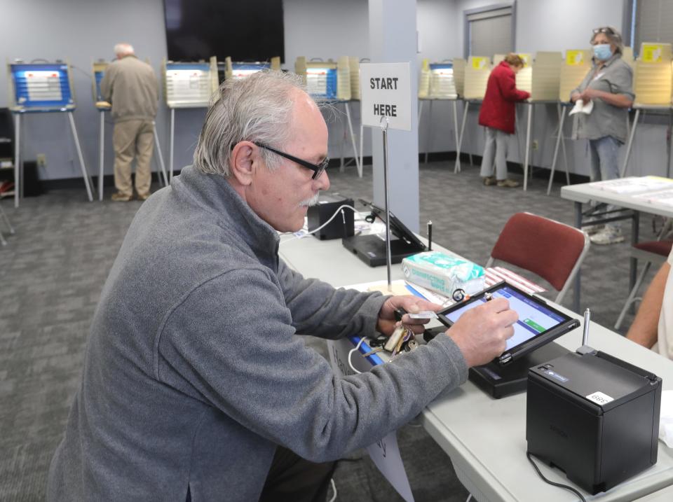 Joseph Porter of Coventry Township signs in to vote Tuesday at Connect Church.