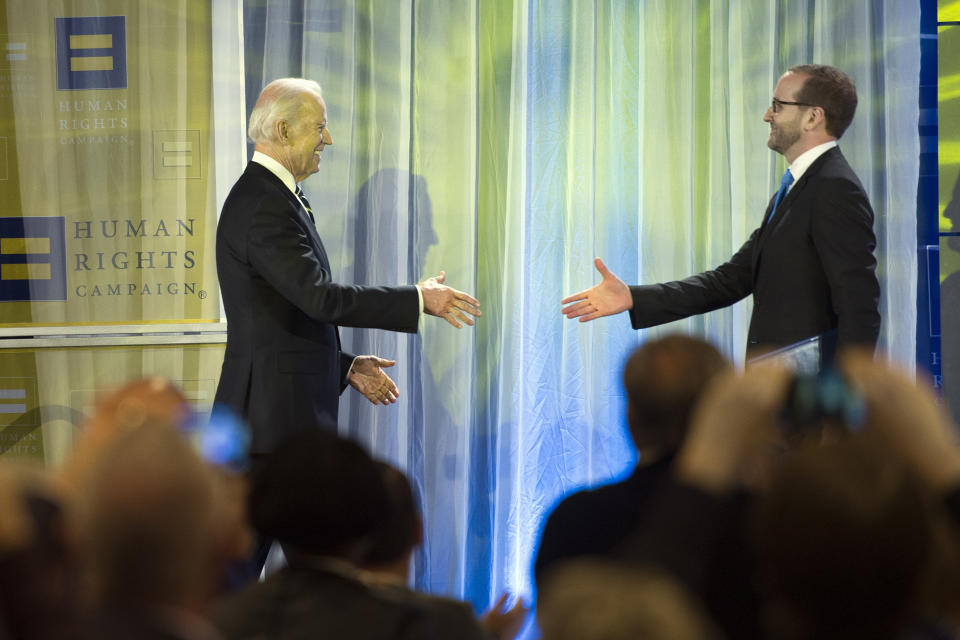 FILE - Vice President Joe Biden reaches to shake hands with Human Rights Campaign President Chad Griffin before addressing the HRC's Spring Equity Convention in Washington, March 6, 2015. Griffin, who led the American Foundation for Equal Rights and the Human Rights Campaign, said it was common for lawmakers to tell him, "You know privately I’m with you, and you know so-and-so in my family is gay or lesbian, but politically, I can’t be out there.” (AP Photo/Cliff Owen, File)