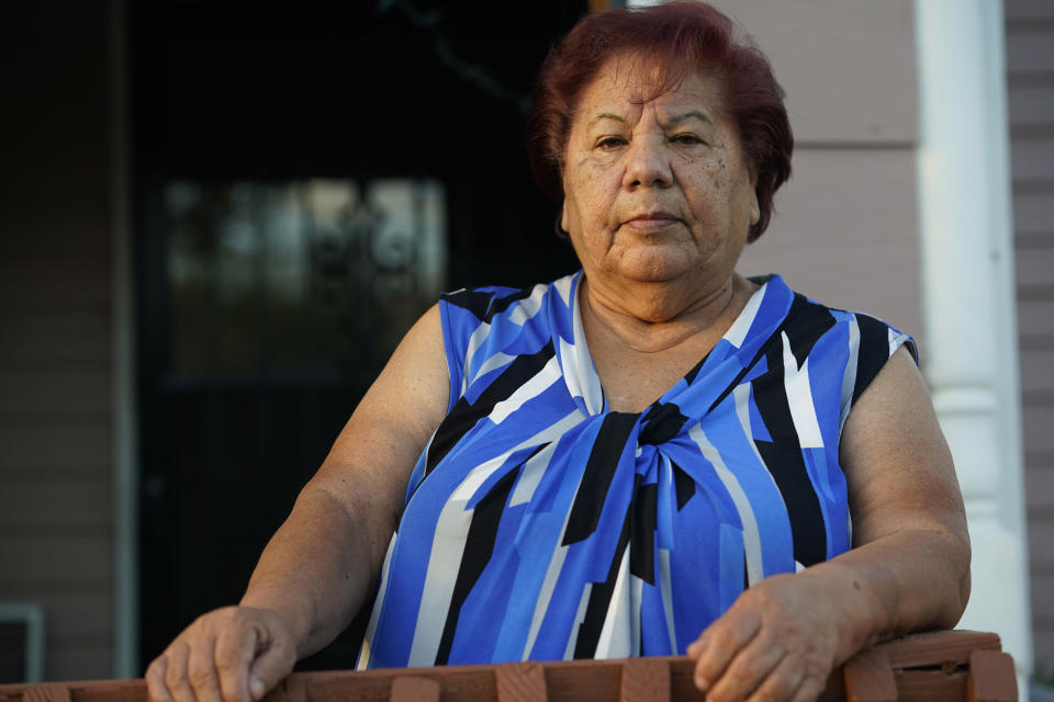 Carolina Sanchez stands outside the home that she shared with her husband, Saul, who died from COVID-19, during an interview Monday, Oct. 12, 2020, in Greeley, Colo. (AP Photo/David Zalubowski)