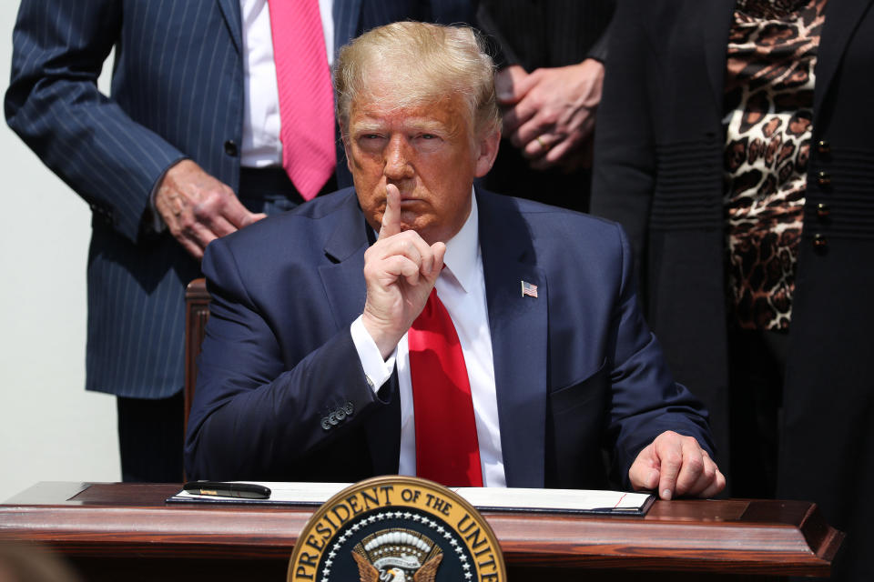 President Trump shushes journalists before signing the Paycheck Protection Program Flexibility Act in June 2020. (Chip Somodevilla/Getty Images)