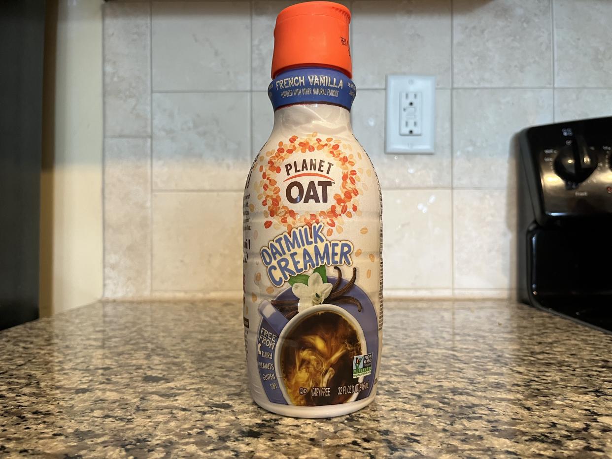 a bottle of planet oat milk creamer