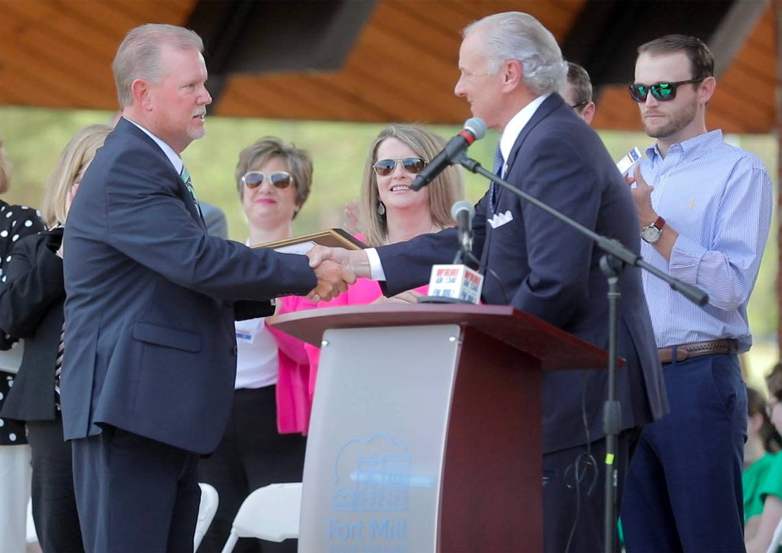 Retired Fort Mill police chief Jeff Helms, left, shakes hands with S.C. Gov. Henry McMaster Thursday in Fort Mill. McMaster gave Helms the Order of the Palmetto — the highest civilian honor in S.C.