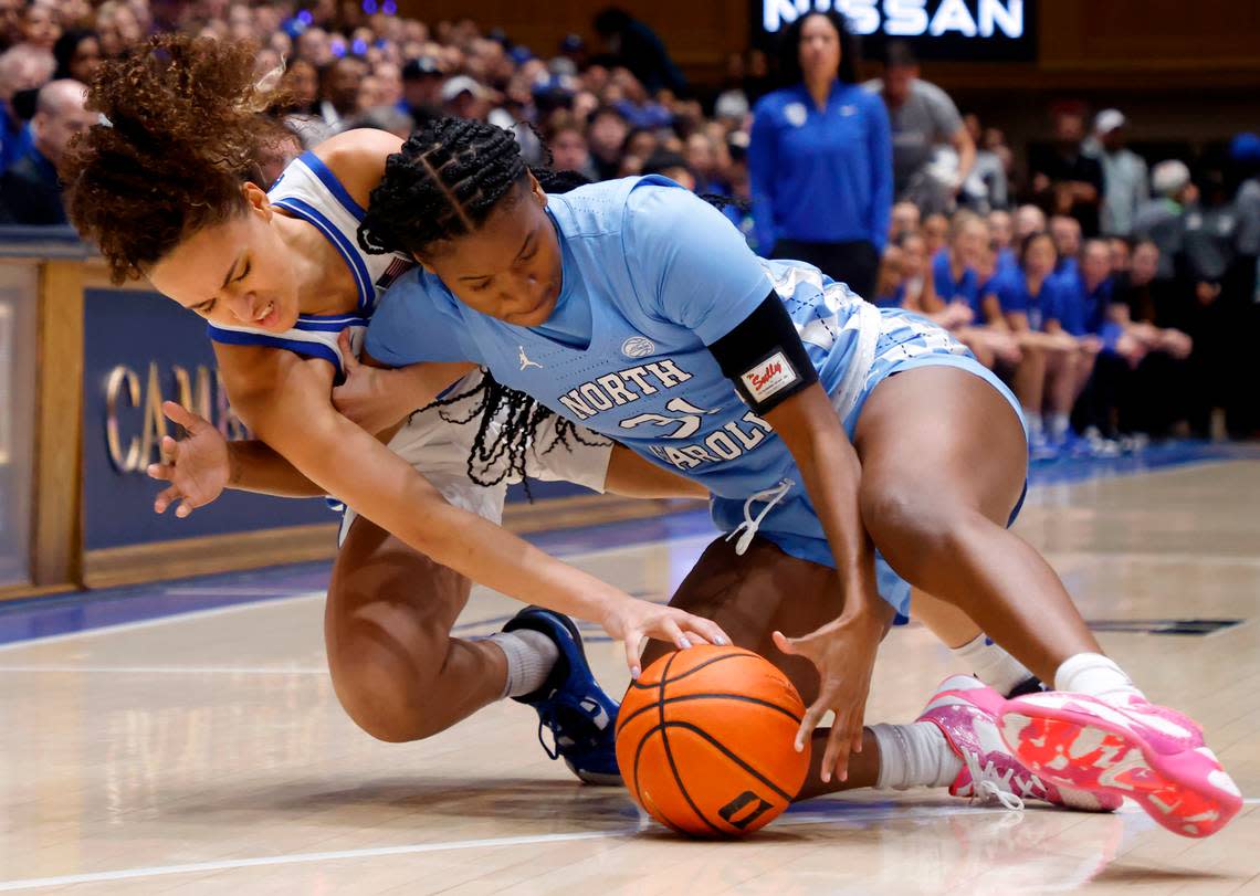 Duke’s Celeste Taylor and North Carolina’s Anya Poole dive for a loose ball during the first half of the Blue Devils’ regular season finale against North Carolina on Sunday, Feb. 26, 2023, at Cameron Indoor Stadium in Durham, N.C.