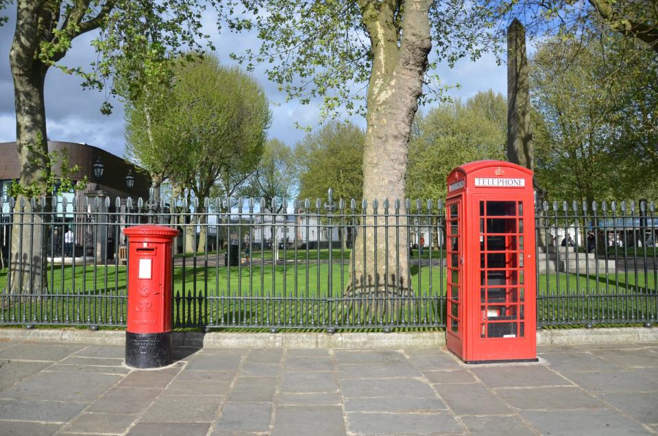 The busy city of London has plenty to do. Check out these tips on visiting the city and how to best enjoy a short trip. Pictured: A British telephone booth in the park on a sunny day