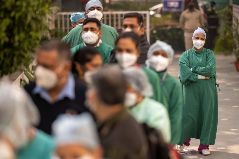 Medical workers wait to be inoculated with a Covid-19 coronavirus vaccine at a hospital in New Delhi on January 16, 2021. (Photo by Jewel SAMAD / AFP) (Photo by JEWEL SAMAD/AFP via Getty Images)