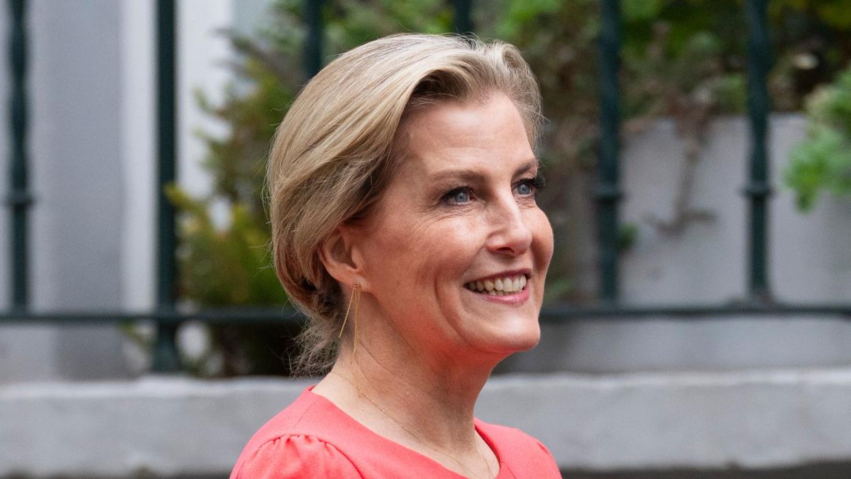 Duchess Sophie smiling in coral dress