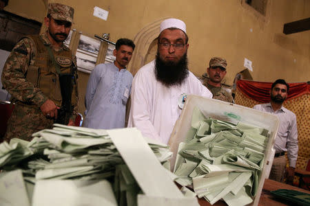 An election official counts ballots after polls closed during the general election in Islamabad, Pakistan, July 25, 2018. REUTERS/Athit Perawongmetha