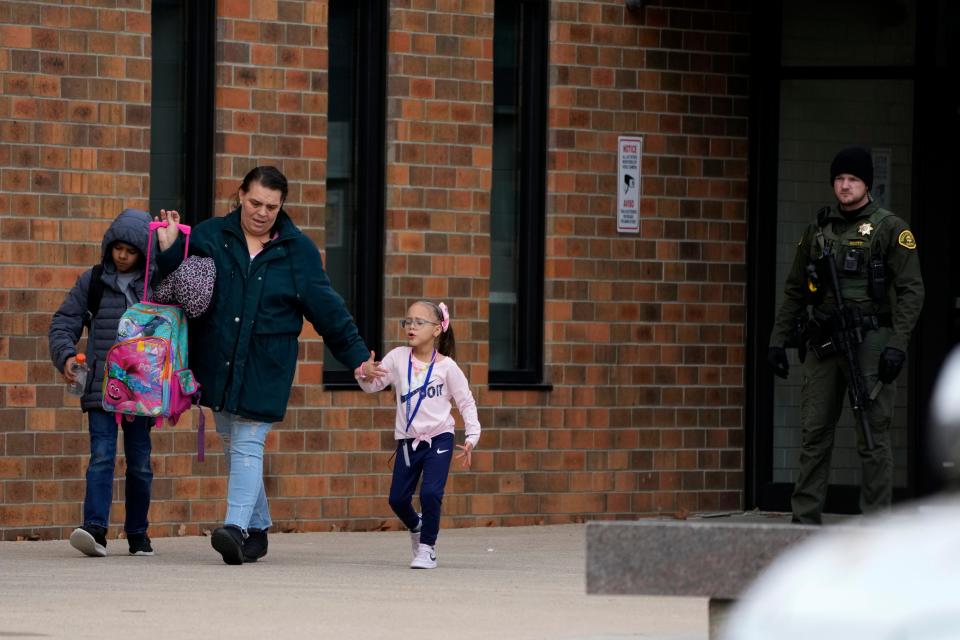 A family leaves the McCreary Community Building after being reunited following a shooting at Perry High School, Thursday, Jan. 4, 2024, in Perry, Iowa. (AP Photo/Charlie Neibergall)