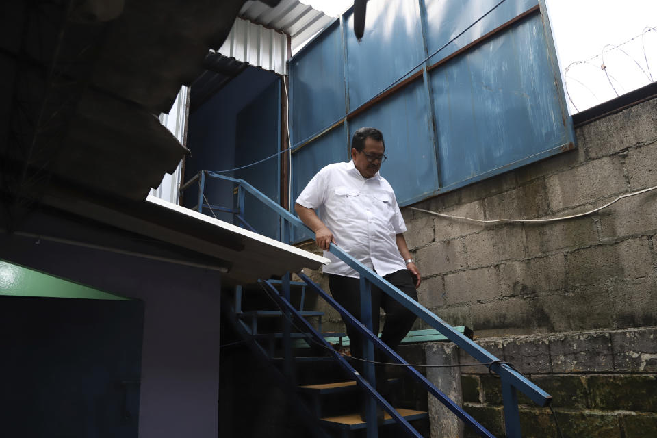 Rev, Nelson Moz descends a flight of stairs from an empty room where former gang members were housed, behind the Eben-Ezer Church, in San Salvador, El Salvador, Saturday, April 29, 2023. Not all evangelical churches in El Salvador open their doors to gang members, but in most marginalized communities there are pastors, like Moz, willing to take the risk. (AP Photo/Salvador Melendez)