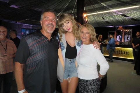 Taylor Swift, center, photographed in 2018 with WYCD-FM program director Tim Roberts, left, and his wife, Lori Roberts.