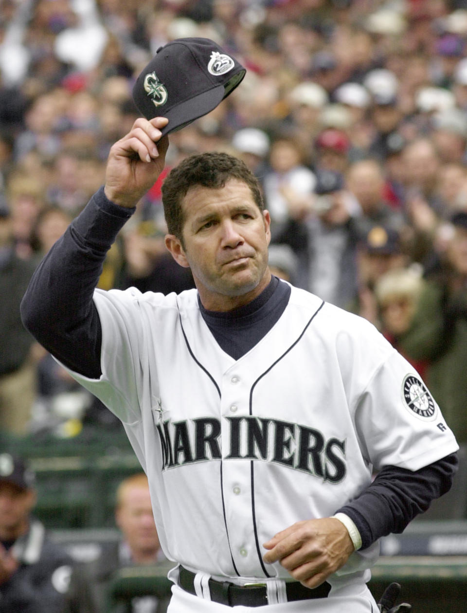 FILE - In this April 1, 2002, file photo, Seattle Mariners' Edgar Martinez tips his cap to the crowd as he is introduced for the baseball team's season opener against the Chicago White Sox in Seattle. Martinez hit a 2-run single in the eighth. The White Sox won 6-5. Martinez hit .312 with 309 home runs in 2,055 career games with the Mariners. His numbers would be even more impressive if he had broken into the majors earlier. Martinez never played more than 100 games in the majors until he was 27. (AP Photo/Elaine Thompson, File)