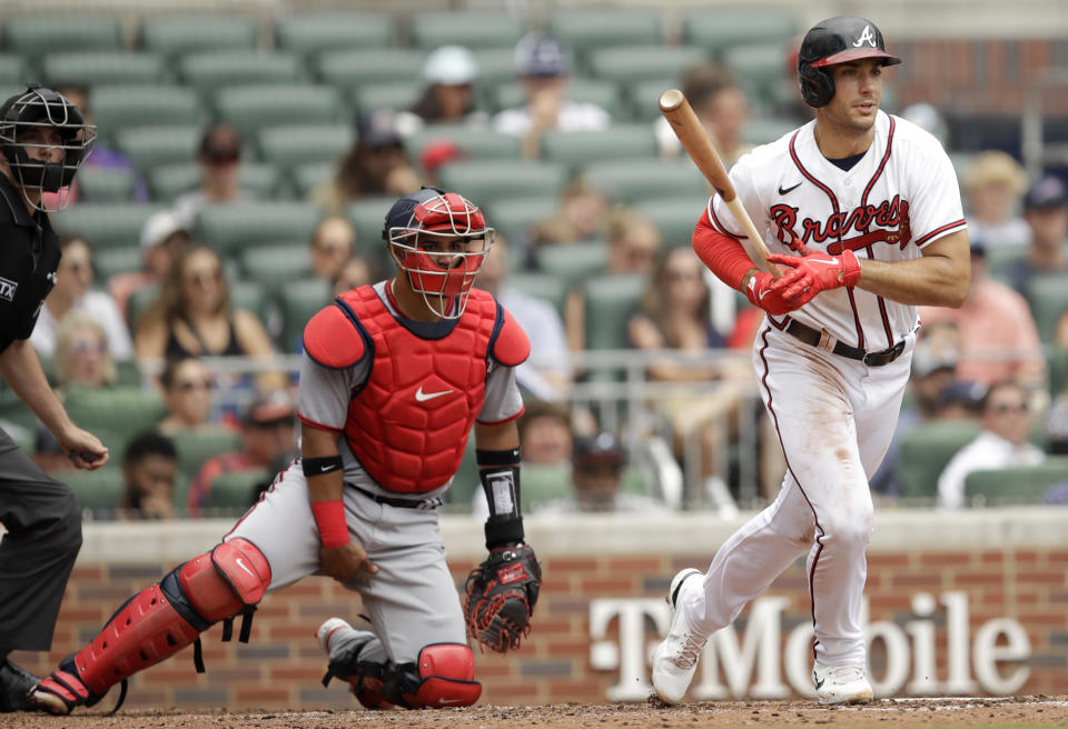 Atlanta Braves' Matt Olson, right, watches his single hit off Washington Nationals' Paolo Espino in the third inning of a baseball game, Sunday, July 10, 2022, in Atlanta. (AP Photo/Ben Margot)