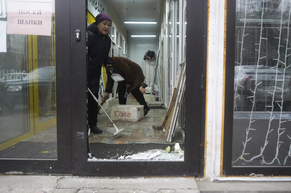 Vendors clean their store that was broken into and looted during clashes in Almaty, Kazakhstan, Monday, Jan. 10, 2022. Kazakhstan's health ministry says over 150 people have been killed in protests that have rocked the country over the past week. President Kassym-Jomart Tokayev's office said Sunday that order has stabilized in the country and that authorities have regained control of administrative buildings that were occupied by protesters, some of which were set on fire. (Vladimir Tretyakov/NUR.KZ via AP)