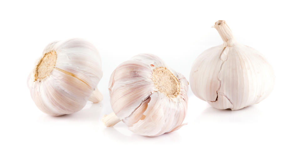 Close-Up Of Garlic Bulbs Against White Background