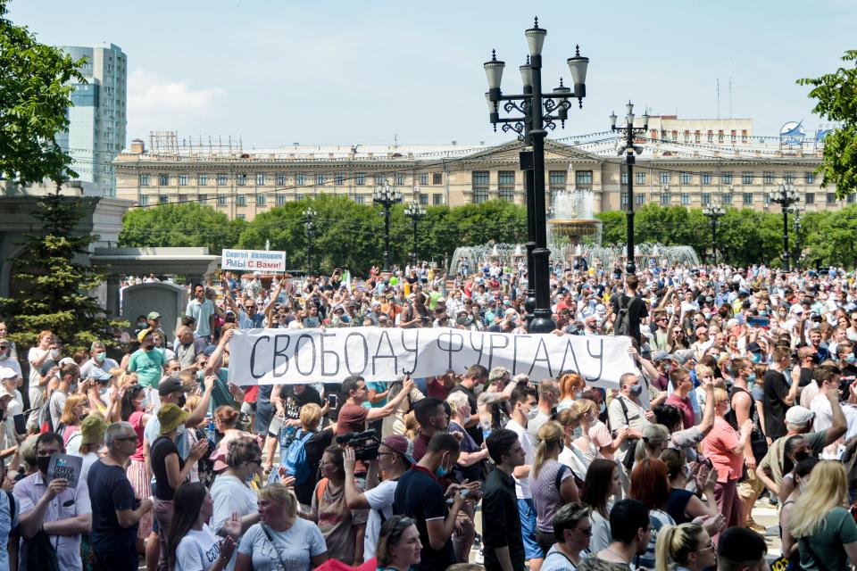 People hold a banner reading "Freedom for Furgal!", during an unauthorised rally in support of Sergei Furgal, the governor of the Khabarovsk region who was arrested a week ago, in the Russian far eastern city of Khabarovsk on July 18, 2020. - Tens of thousands of people rallied on July 18 in Khabarovsk in new protests in support of a popular governor and in a rare show of defiance against the Kremlin. Sergei Furgal was arrested last week on charges of ordering the killings of businessmen 15 years ago. (Photo by Aleksandr Yanyshev / AFP) (Photo by ALEKSANDR YANYSHEV/AFP via Getty Images)