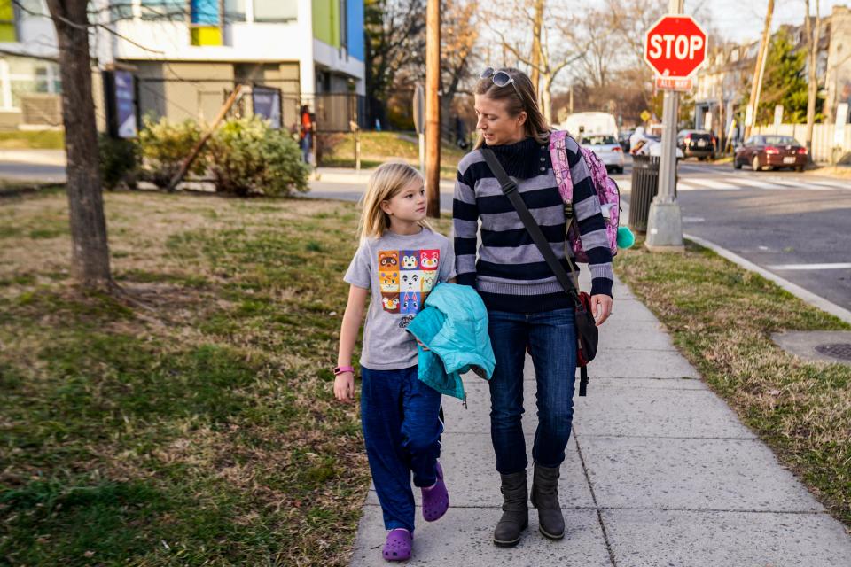 Alison Ray Cavanagh picks up her daughter, Elsa,  from E.L. Haynes Public Charter School in 2021.