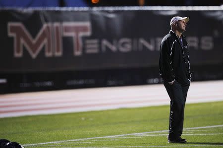 Head coach Chad Martinovich watches his team warm up for a Massachusetts Institute of Technology (MIT) Engineers football team practice in Cambridge, Massachusetts November 13, 2014. REUTERS/Brian Snyder