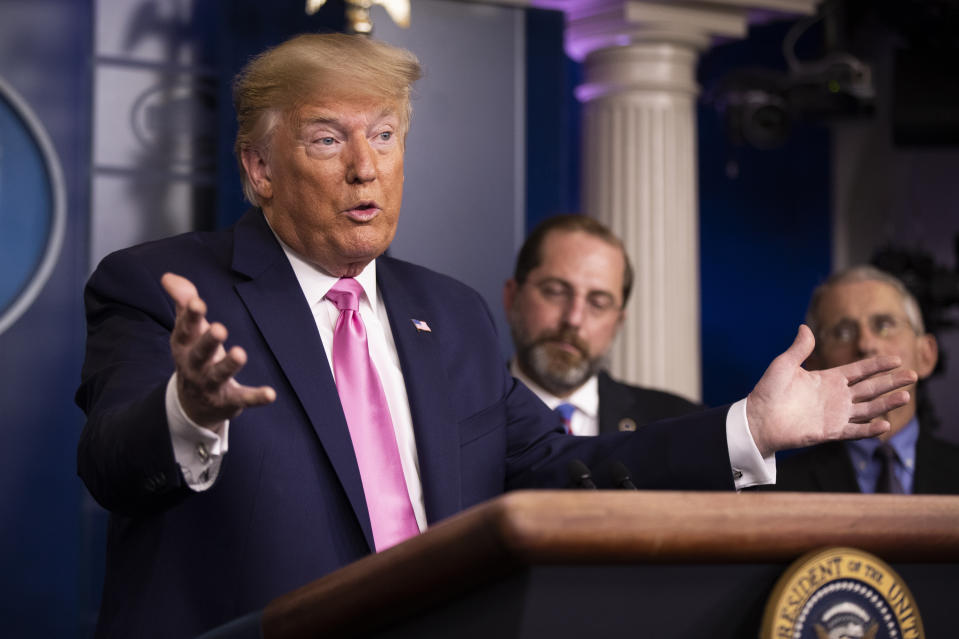 President Donald Trump with Department of Health and Human Services Secretary Alex Azar, back center, and Director of the National Institute of Allergy and Infectious Diseases at the National Institutes of Health Anthony Fauci, right, and other members of the president's coronavirus task force speaks during a news conference at the Brady press briefing room of the White House, Wednesday, Feb. 26, 2020, in Washington. (AP Photo/Manuel Balce Ceneta)