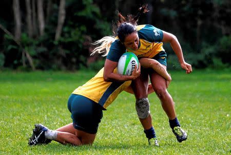 Member of the Australian Women's rugby sevens Olympic team Amy Turner is tackled as she runs with the ball during a team training session in Sydney, Australia, July 22, 2016. Picture taken July 22, 2016. REUTERS/David Gray