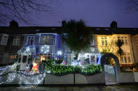 Houses are decorated with seasonal lights in London, Thursday, Dec. 23, 2021. The British government says it won't introduce any new coronavirus restrictions until after Christmas, and called early studies on the severity of the omicron variant encouraging. Health Secretary Sajid Javid said two studies suggesting omicron carries a significantly lower risk of hospitalization than the previously dominant delta strain was "encouraging news."(AP Photo/Kirsty Wigglesworth)