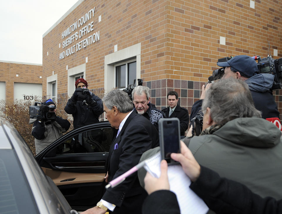 Attorney James Voyles, center left, and Indianapolis Colts owner Jim Irsay, center right, leave the Hamilton County Jail in Indianapolis, Monday, March 17, 2014. Irsay was released from jail Monday after being held overnight following a traffic stop in which police said he failed sobriety tests and had multiple prescription drugs inside his vehicle. Irsay was pulled over late Sunday after he was spotted driving slowly near his home in suburban Carmel, stopping in the roadway and failing to use a turn signal. (AP Photo/Alan Petersime)