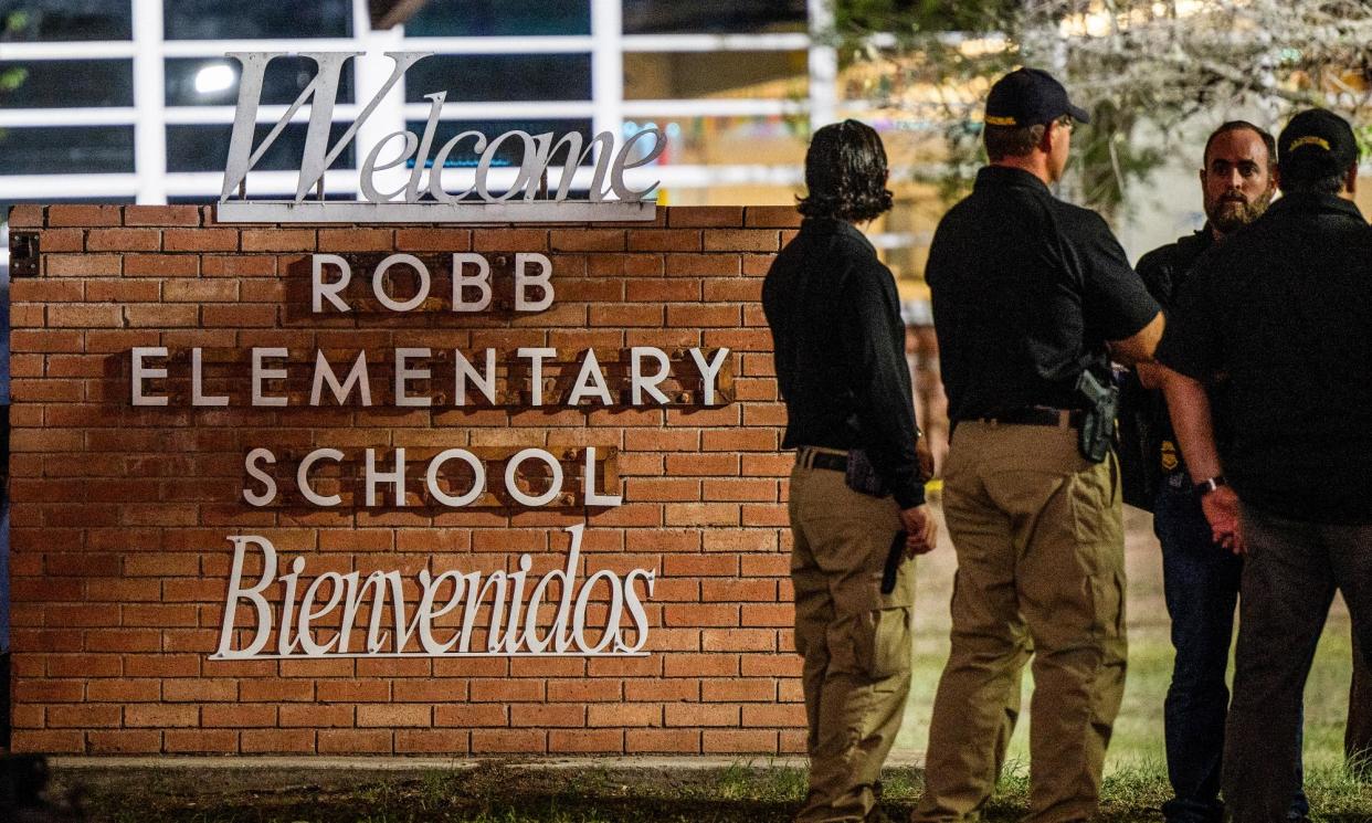 <span>Law enforcement officers outside Robb elementary school following the mass shooting on 24 May 2022 in Uvalde, Texas.</span><span>Photograph: Brandon Bell/Getty Images</span>