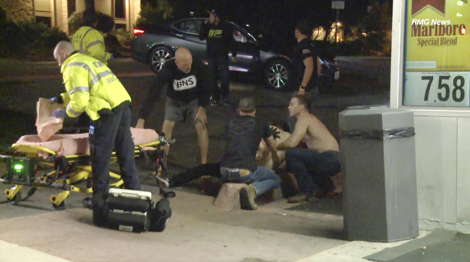 FILE - In this Wednesday evening, Nov. 7, 2018 file image taken from video a victim is treated near the scene of a shooting, in Thousand Oaks, Calif. A hooded gunman dressed entirely in black opened fire on a crowd at a country dance bar holding a weekly "college night" in Southern California, killing multiple people and sending hundreds fleeing. The 12 people killed in a mass shooting and gun battle at the Southern California country-western bar a year ago have been remembered in a public park memorial called The Healing Garden. The garden was to be dedicated Thursday, Nov, 7. (RMG News via AP, File)