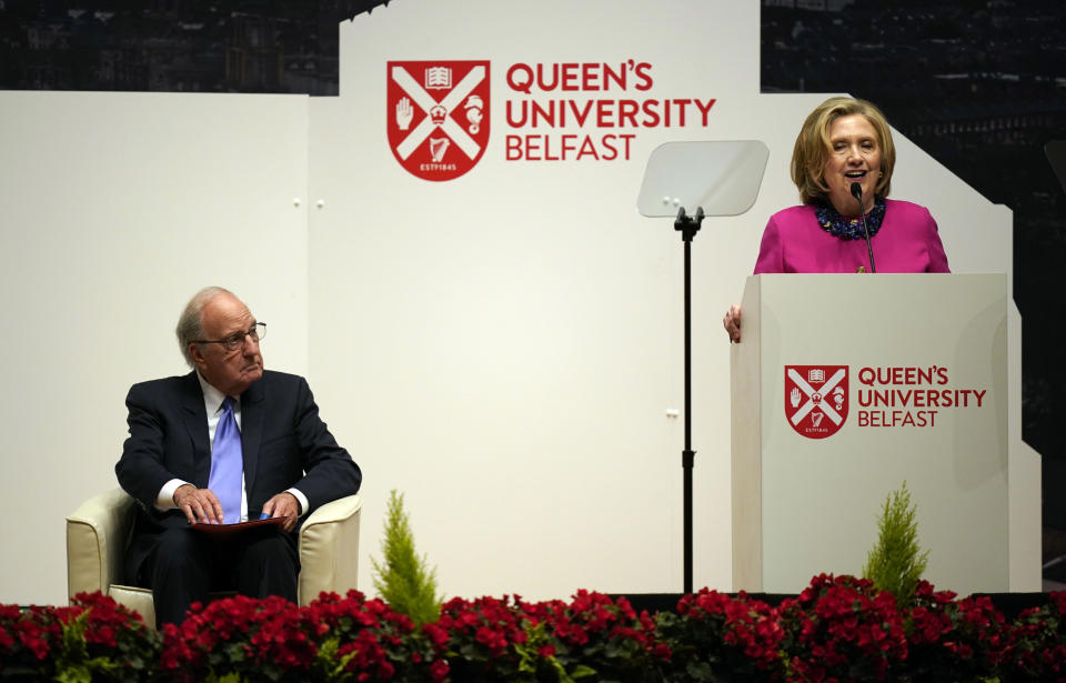 Former U.S. Sen. and chairman of negotiations George Mitchell, left, listens to former US Secretary of State Hillary Clinton speak on the first day of a three-day international conference at Queen's University Belfast to mark the 25th anniversary of the Good Friday Agreement, in Belfast, Northern Ireland, Monday, April 17, 2023. Former U.S. President Bill Clinton and past leaders of the U.K. and Ireland are gathering in Belfast on Monday, 25 years after their charm, clout and determination helped Northern Ireland strike a historic peace accord. (Niall Carson/PA via AP)