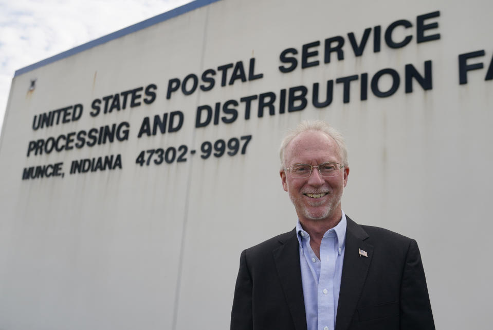 Doug Brown, postal staffer and president of the American Postal Workers Union chapter in Indiana, poses for a picture outside of a post office facility, Monday, Aug. 17, 2020, in Muncie, Ind. The U.S. Postal Service is expected to play a central role in this year's presidential elections with so many states promoting voting by mail amid the coronavirus pandemic. (AP Photo/Darron Cummings)