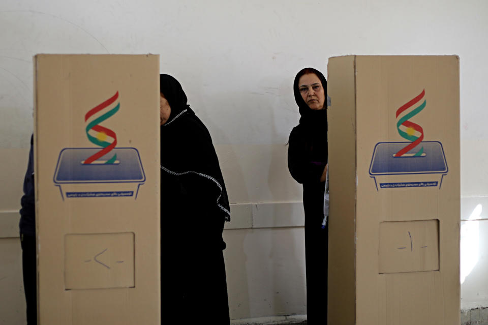 FILE - In this Sept. 30, 2018 file photo, Iraqi Kurdish women cast their ballots during parliamentary elections in Irbil, Iraq. The government of Iraq's autonomous Kurdish region said Sunday, Oct. 21, 2018, that the party that led the region into its ill-fated independence referendum last year has won the most seats in regional parliamentary elections. The elections commission says the Kurdistan Democratic Party won 45 seats, 12 seats short of an outright majority in the 111-seat body. (AP Photo/Salar Salim, File)