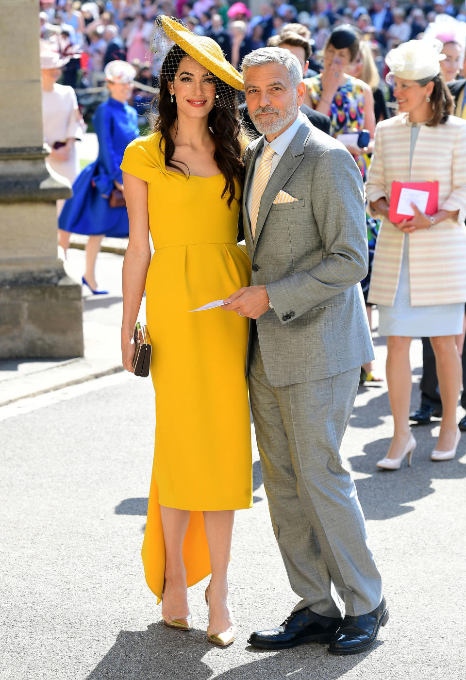 Amal Clooney in Stella McCartney at the royal wedding with her husband, George. (Photo: Getty Images)