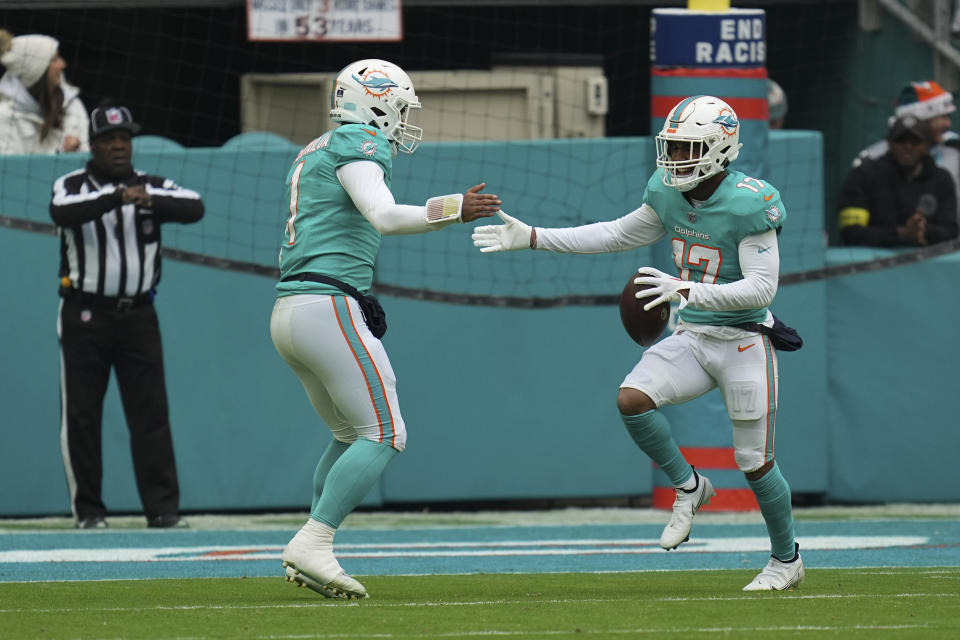 Miami Dolphins wide receiver Jaylen Waddle (17), right, celebrates with Miami Dolphins quarterback Tua Tagovailoa (1) after scoring a touchdown during the first half of an NFL football game, Sunday, Dec. 25, 2022, in Miami Gardens, Fla. (AP Photo/Jim Rassol)