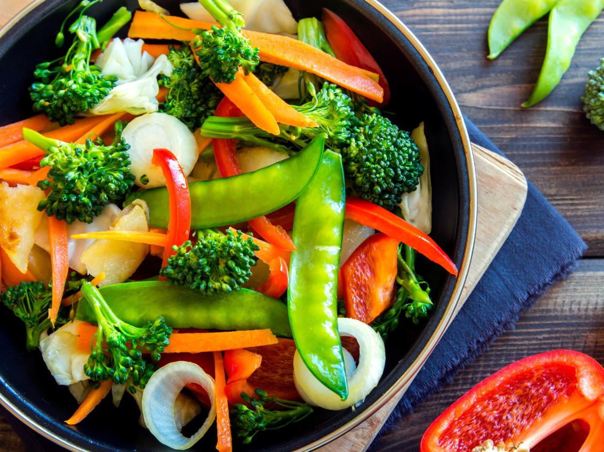 Healthy stir fried vegetables in the pan and ingredients close up