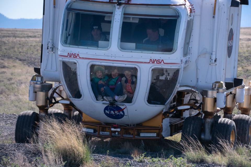 Reni Deasy (6, left bottom), Baya Deasy (6, center bottom) and Eden Deasy (4, right bottom, all the children of Flagstaff Mayor Paul Deasy) ride in the Artemis Rover during a press briefing on Oct. 24, 2022, at NASA's Desert Research and Technology Studies (Deserts RATS) Artemis' Rover Mission Simulations site at Black Point Lava Flow, located 40 miles north of Flagstaff.