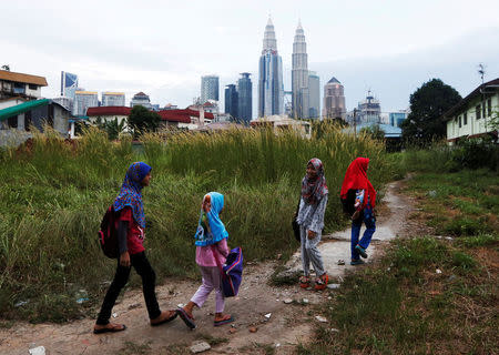 FILE PHOTO: Girls make their way home after school in Kuala Lumpur, Malaysia, February 10, 2016. REUTERS/Olivia Harris/File Photo