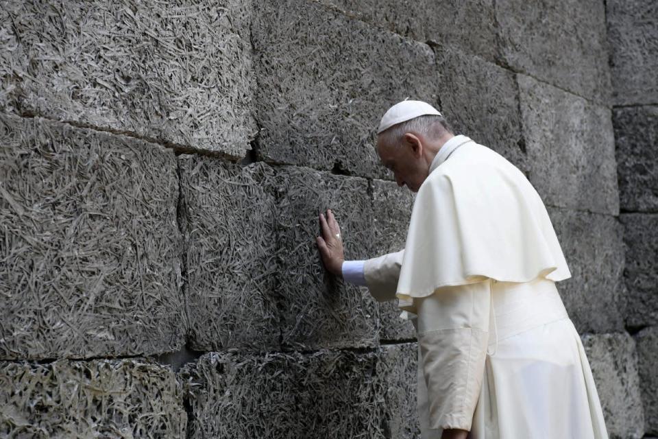 Pope Francis  prays in front of the death wall at the former Nazi concentration camp of Auschwitz in Oswiecim, Poland, Friday, July 29, 2016. Pope Francis paid a somber visit to the Nazi German death camp of Auschwitz-Birkenau Friday, becoming the third consecutive pontiff to make the pilgrimage to the place where Adolf Hitler’s forces killed more than 1 million people, most of them Jews. (L'Osservatore Romano /Pool Photo via AP)