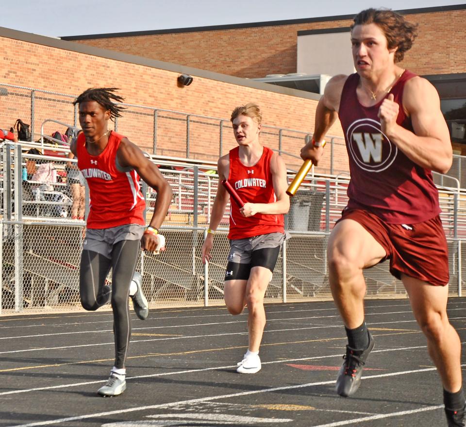 Coldwater's Kaden Lewis hands off to teammate Phanom Dompierre during the 400 meter relay at Parma Western High School on Monday.