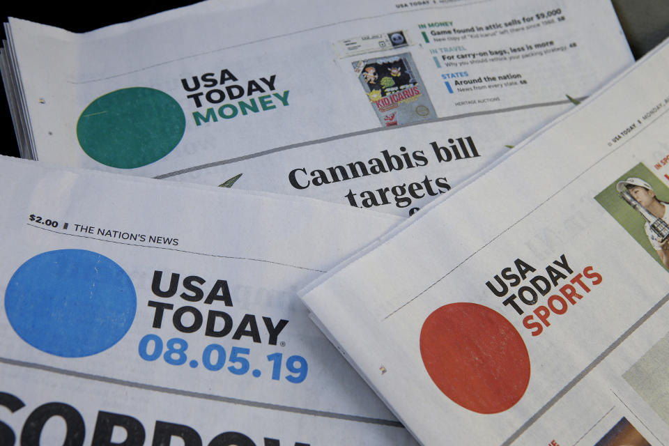 FILE - In this Aug. 5, 2019, file photo, sections of a USA Today newspaper rest together in Norwood, Mass. Gannett Co., Inc. reports earnings Thursday, Feb. 27. (AP Photo/Steven Senne, File)