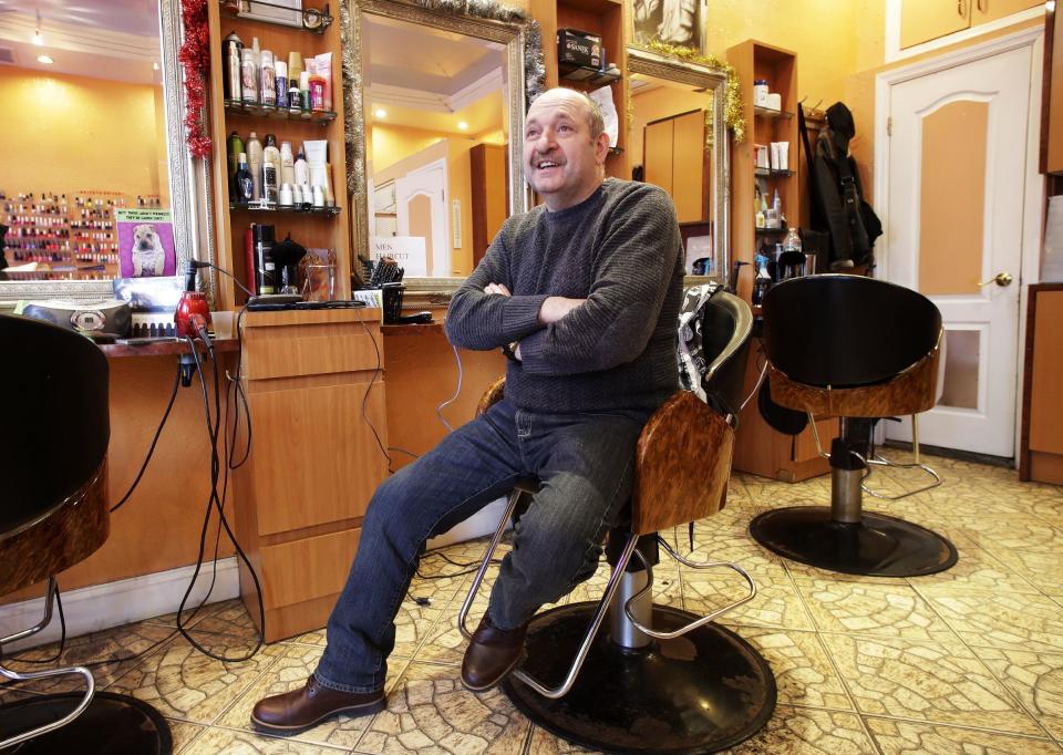 In this Dec. 16, 2016 photo, Yefim Kacher, owner of a Brighton Beach hair salon in the Brooklyn borough of New York, talks about the election of Donald Trump. Kacher, who said he voted for Trump because of his promise to slash taxes, was among the few who said there appears to be sufficient evidence that Russia tried to sway the U.S. election outcome. "Relations will improve thanks to common sense because no one wants to escalate the confrontation with Russia," he said in Russian. (AP Photo/Mark Lennihan)