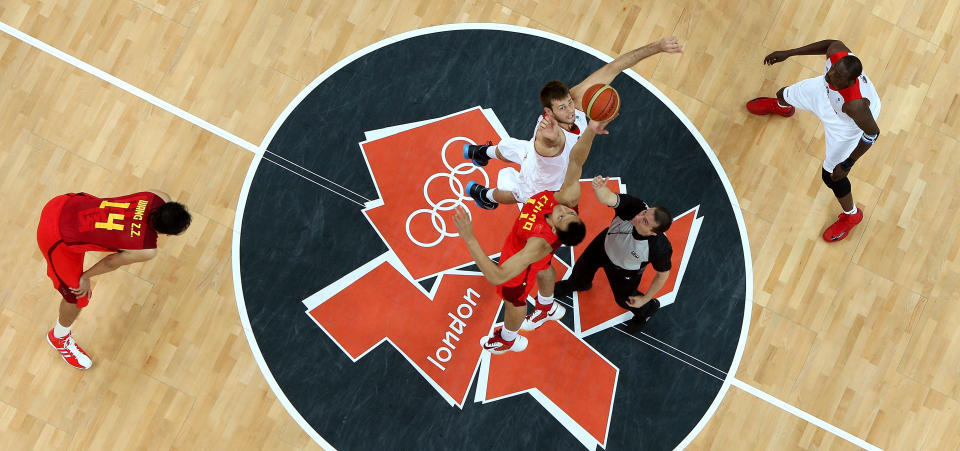 LONDON, ENGLAND - AUGUST 06: Joel Freeland #11 of Great Britain fights for control of the opening tip-off against Yi Jianlian #11 of China during the Men's Basketball Preliminary Round match on Day 10 of the London 2012 Olympic Games at the Basketball Arena on August 6, 2012 in London, England. (Photo by Rob Carr/Getty Images)