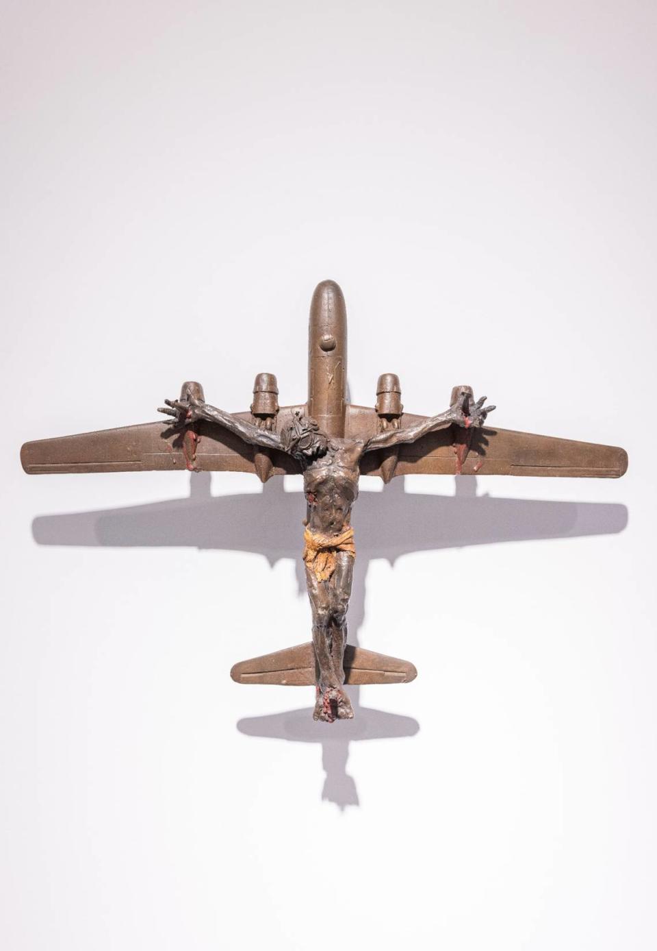 San Francisco artist Al Farrow critiques the use of religion to justify war in his artwork. In this sculpture, Christ is depicted on a fighter jet.