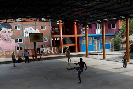 Migrants from Central America play football inside a migrant shelter, known as The 72, in Tenosique, Tabasco, Mexico, April 10, 2017. REUTERS/Carlos Jasso