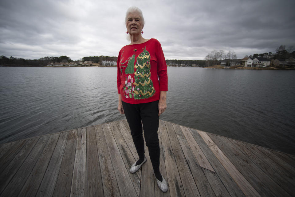 Wanda Olson poses for a photo, Friday, Dec. 17, 2021, in Villa Rica, Ga. When Olson’s son-in-law died in March after contracting COVID-19, she and her daughter had to grapple with more than just their sudden grief. They had to come up with money for a cremation. Even without a funeral, the bill came to nearly $2,000, a hefty sum that Olson initially covered. (AP Photo/Mike Stewart)