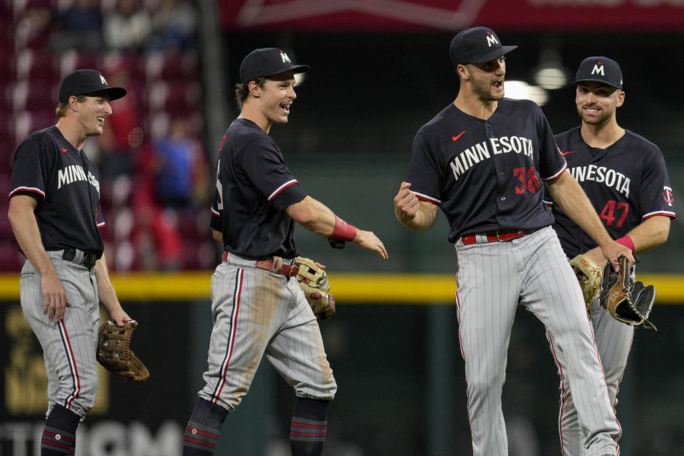 Minnesota Twins' Andrew Stevenson, from left to right, Max Kepler, Matt Wallner (38) and Edouard Julien (47) celebrate following a baseball game against the Cincinnati Reds in Cincinnati, Tuesday, Sept. 19, 2023. (AP Photo/Jeff Dean)