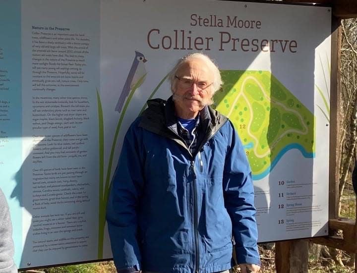 Dr. Bob Collier, who died New Year's Eve 2020, is pictured in front of the sign for the preserve he donated in honor of his grandmother Stella Moore Collier.