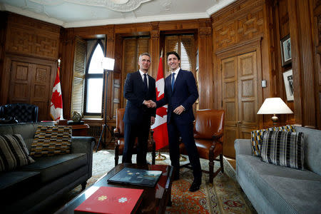 Canada's Prime Minister Justin Trudeau shakes hands with NATO Secretary General Jens Stoltenberg during a meeting in Trudeau's office on Parliament Hill in Ottawa, Ontario, Canada, April 4, 2018. REUTERS/Chris Wattie