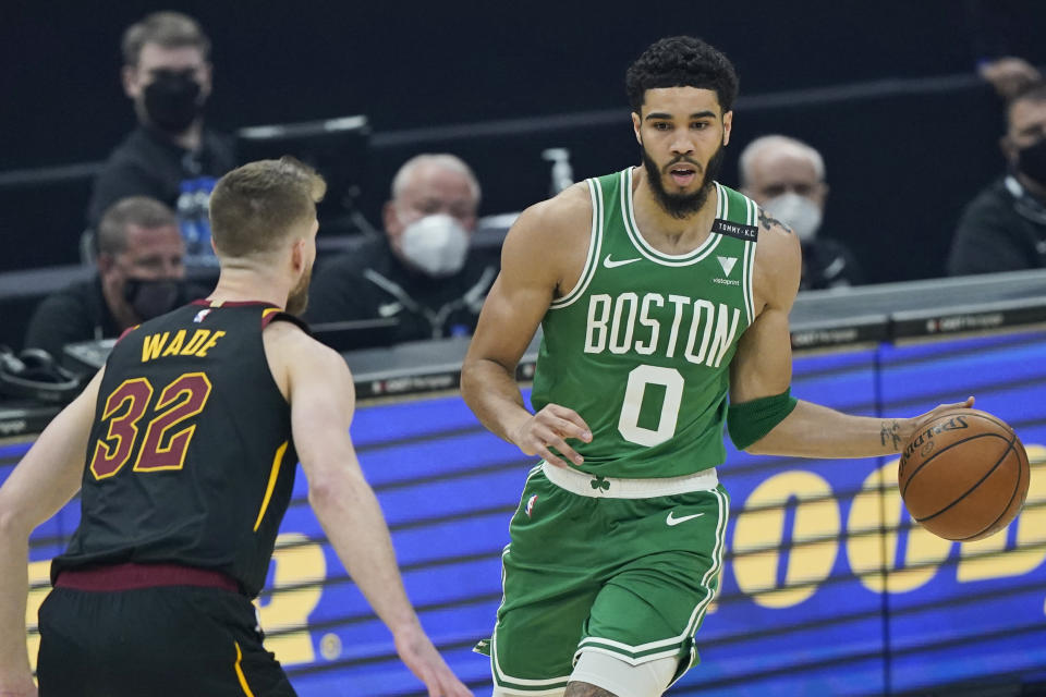 Boston Celtics' Jayson Tatum (0) drives against Cleveland Cavaliers' Dean Wade (32) in the first half of an NBA basketball game, Wednesday, May 12, 2021, in Cleveland. (AP Photo/Tony Dejak)