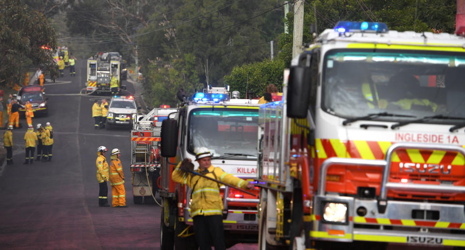 Line of NSW RFS firetrucks fighting bushfire in South Turramurra. 