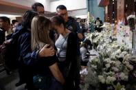 People gather to commemorate a student who died after he fell during a protest in Hong Kong